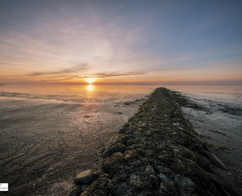 Strandhoofd tijdens zonsondergang Harlingen